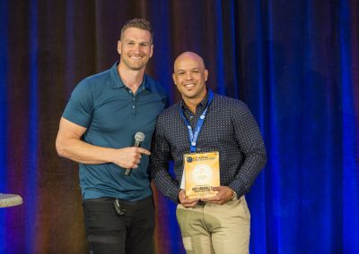 Dave Jack presents Javy Caraballo his Fitness Business Owner of the Year finalist award at Fitness Revolution's EFPS 2019.