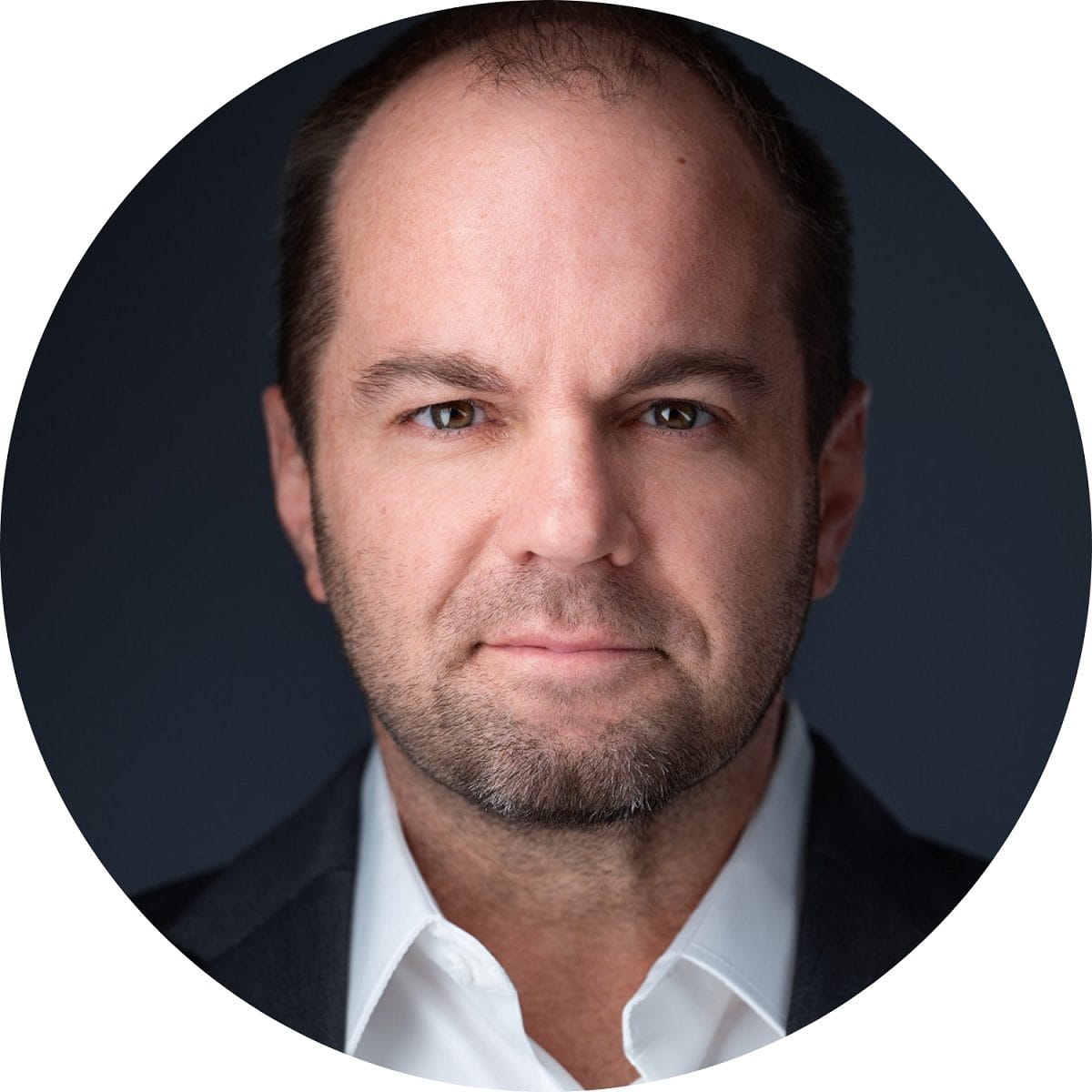 Entrepreneur and strategic advisor Nick Berry's headshot on a dark gray background.